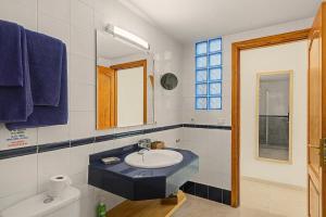 a bathroom with a sink and a mirror at Callao Beach 5 in Arrieta +15 photos