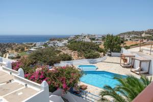 a villa with a swimming pool and a view of the ocean at Hotel Albatros in Karpathos