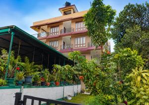 a building with plants in front of it at Aditi in Thekkady
