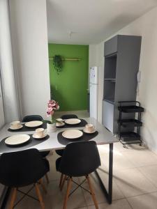 a kitchen with a table with chairs and a refrigerator at Bem-vindo ao seu refúgio em Palhoça in Palhoça