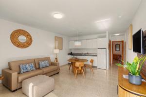 a living room with a couch and a table at Callao Beach 5 in Arrieta