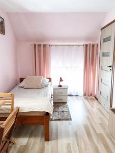 a bedroom with a bed and a window at Pokoje gościnne u Antka in Krynki