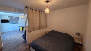 a bedroom with a bed and a room with a window at Maison bord de Loire Logement A in Saint-Rémy-la-Varenne