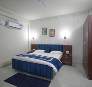 a bedroom with a blue and white bed in it at Hotel Riddhinn6 in Jalandhar