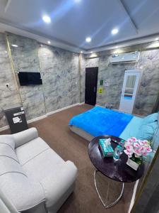 a living room with a couch and a table at Holiday Abu Dhabi in Abu Dhabi
