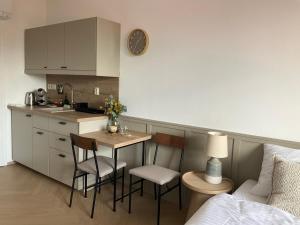 a kitchen with a table and chairs in a room at Ivanka Apartments in Ivanka pri Dunaji +22 photos