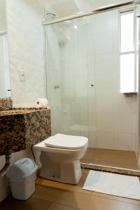 a bathroom with a toilet and a shower at Hotel Appel in Santa Maria +39 photos