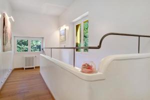 a hallway with white walls and a staircase with a bowl on it at Villa Rêve d'Azur in Grasse +84 photos