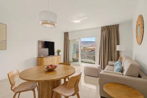 a living room with a table and a couch at Callao Beach 10 in Arrieta
