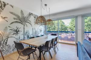 a dining room with a long table and chairs at La Parenthèse Paimpolaise in Paimpol