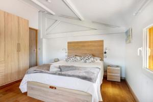a bedroom with a large bed with white walls at Villa Rêve d'Azur in Grasse