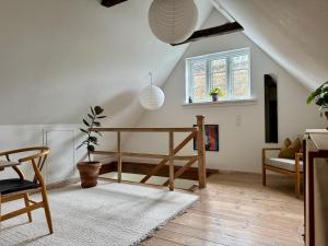 a living room with a table and a chair at Fred & Lyst in Stenløse