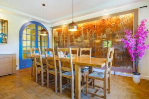 a dining room with a wooden table and chairs at Villa Rêve d'Azur in Grasse