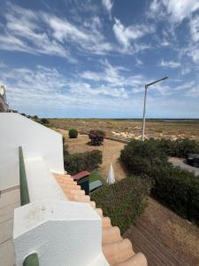 a staircase with a view of the ocean from a house at Sunset Ria in Tavira +7 photos