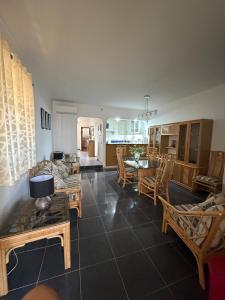 a living room with a couch and a table and chairs at Sunset Ria in Tavira