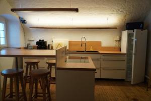 a kitchen with a counter and some bar stools at S'Platzl in Wenns