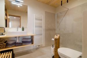 a bathroom with a sink and a toilet and a mirror at Pension Ferienwohnung Baarblick in Donaueschingen +166 photos