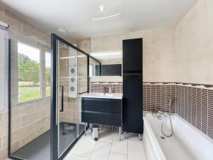 a bathroom with a sink and a tub and a shower at L'Abri Côtier, maison spacieuse avec jardin in Pendé +22 photos
