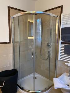 a shower with a glass door in a bathroom at Haus Priller in Sillian +45 photos