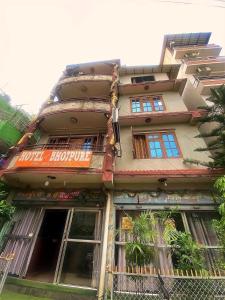 a building with a sign on the side of it at Hotel New Bhojpure in Kathmandu