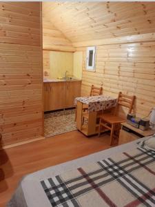 a room with a table and chairs in a cabin at Otto's House in Ambrolauri