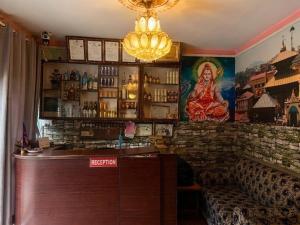 a bar with a large painting on the wall at Hotel New Bhojpure in Kathmandu