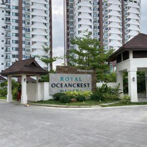 a sign for the royal oceanominium in front of a building at Mely's Condotel Mactan in Mactan Island