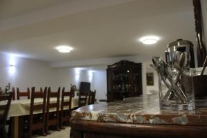 a table with a glass vase filled with silver utensils at Agroturystyka u Basi i Waldka in Zelwa +73 photos