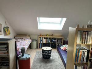 a bedroom with a bed and book shelves and a window at Maison de campagne in Chièvres +8 photos