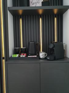 a black shelf with a microwave and a coffee maker at Sterling House in Timişoara