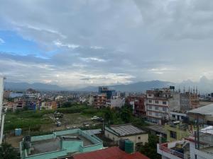 a view of a city with buildings and mountains at Hotel New Bhojpure in Kathmandu +19 photos