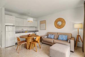 a kitchen and a living room with a table and a couch at Callao Beach 9 in Arrieta