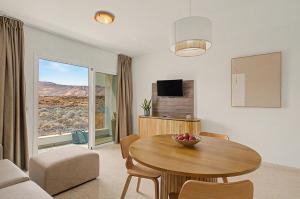 a living room with a table with a bowl of fruit on it at Callao Beach 9 in Arrieta