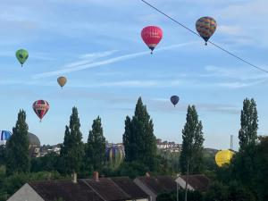 a group of hot air balloons flying in the sky at Ilsyn Grove in Brislington