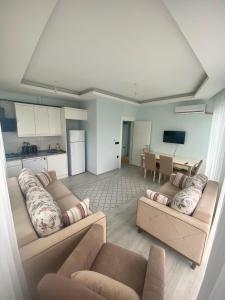 a large living room with two couches and a kitchen at TURKERHOMe in Ordu