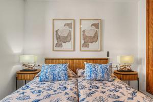 a bedroom with a bed with two lamps on it at Callao Beach 9 in Arrieta +16 photos