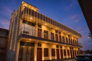 a building with lights on the side of it at Hotel Ramkesarrai in Ayodhya