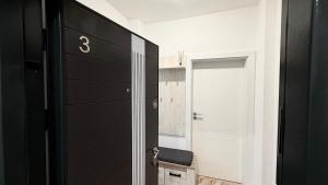 a bathroom with a black door and a mirror at DREAM HOUSE Apartaments in Bistriţa +71 photos