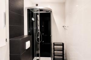 a shower with a glass door in a bathroom at Velocity boutique hotel in Zandvoort +50 photos