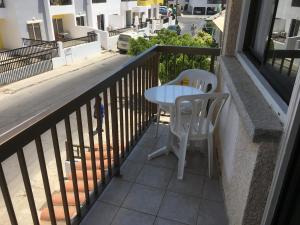 a white table and two chairs on a balcony at Mandali Court in Ayia Napa