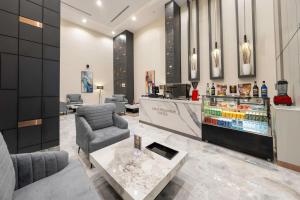 a lobby of a store with a bar and chairs at Garden Melenium - Jeddah in Jeddah
