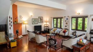 a living room with a table and chairs at Ivy Hill in Yedapalli