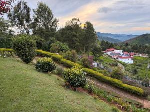 a garden on a hill with houses in the background at Ivy Hill in Yedapalli
