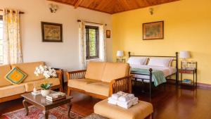 a living room with a bed and a couch at Ivy Hill in Yedapalli