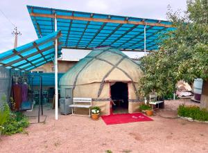 a large iguana house with a blue roof at "AlmUrUt" Guest House in Bokonbayevo