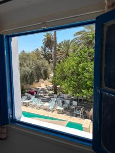 a view of a swimming pool from a window at CoZi at Dar Faiza in Houmt Souk
