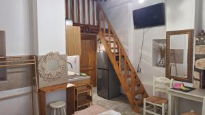 a kitchen with a staircase and a refrigerator in a room at Cavo Paradise Studio Cyclades in Kimolos