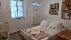 a bedroom with a bed with towels on it at Cavo Paradise Studio Cyclades in Kimolos