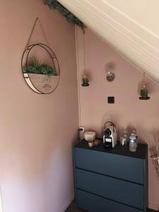 a room with a dresser and a mirror on the wall at Chambre d'hôte in Maligny