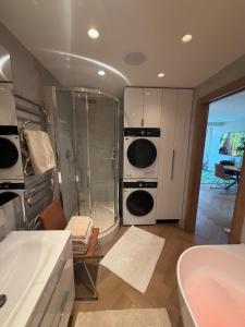 a bathroom with a shower and a sink and a tub at ViSky Ap in Visaginas +63 photos